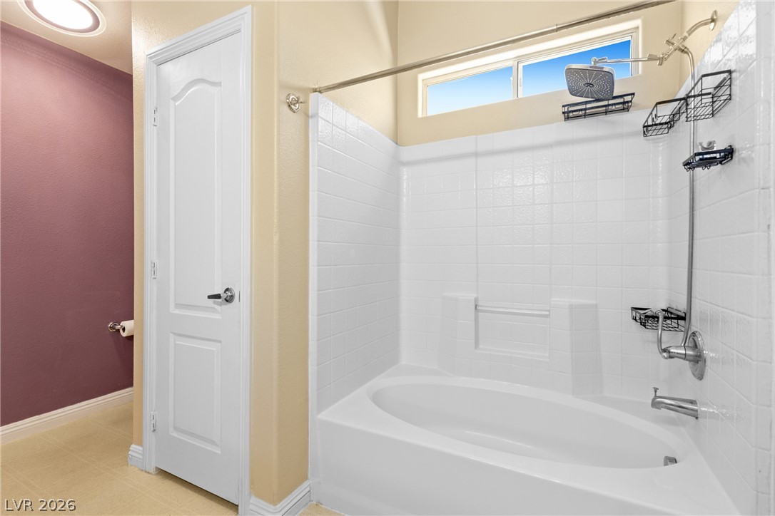8934 Deep Ridge Court Las Vegas, NV 89178 - Photo 26 of 47 A well-appointed bathroom with a pristine tub-shower combo and elegant overhead window.