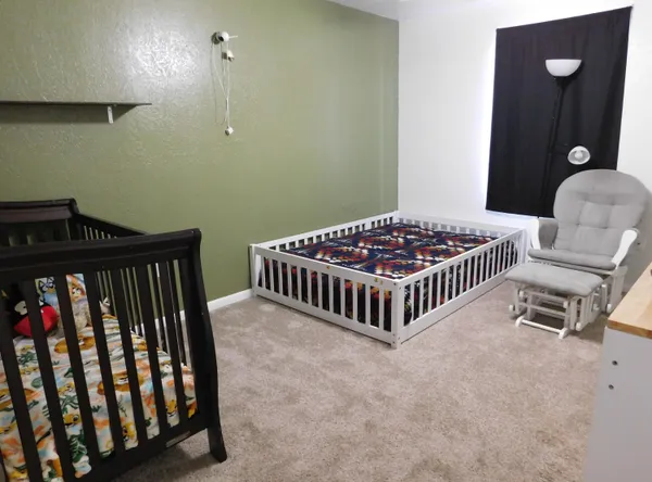 a bedroom with bed and a chandelier
