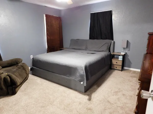 a bedroom with a bed and a couch