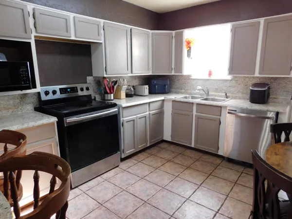 a kitchen with a stove a sink and a microwave