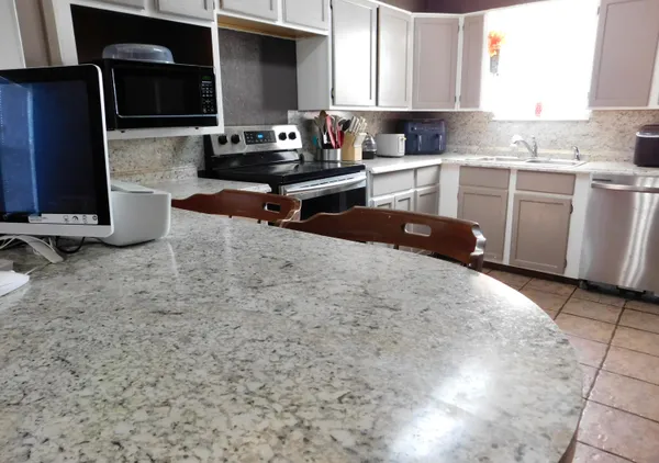 a kitchen with a sink a stove and cabinets
