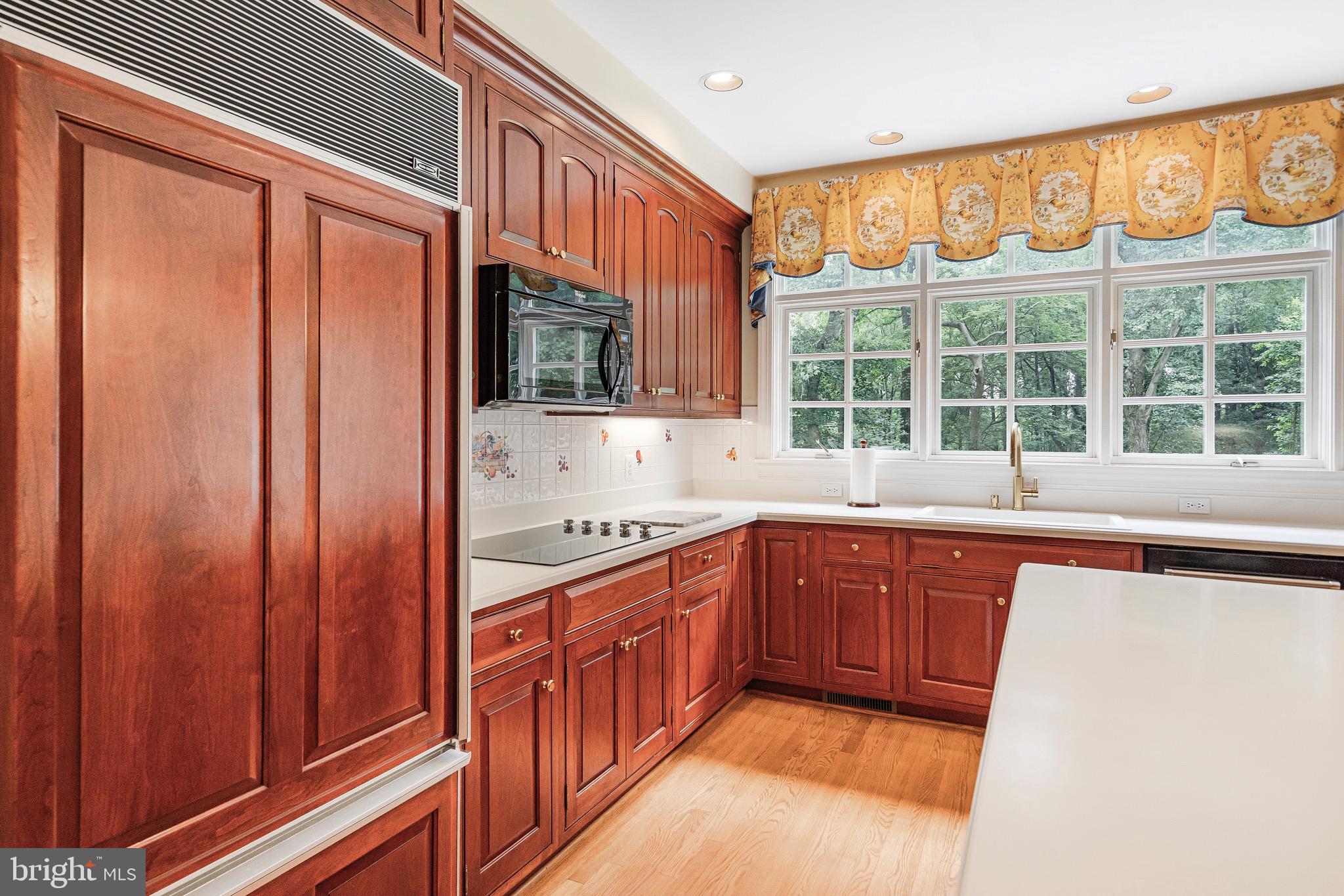 965 St Stephens Church Road Gambrills, MD 21054 - Photo 13 of 43 a kitchen with stainless steel appliances granite countertop a sink and a refrigerator