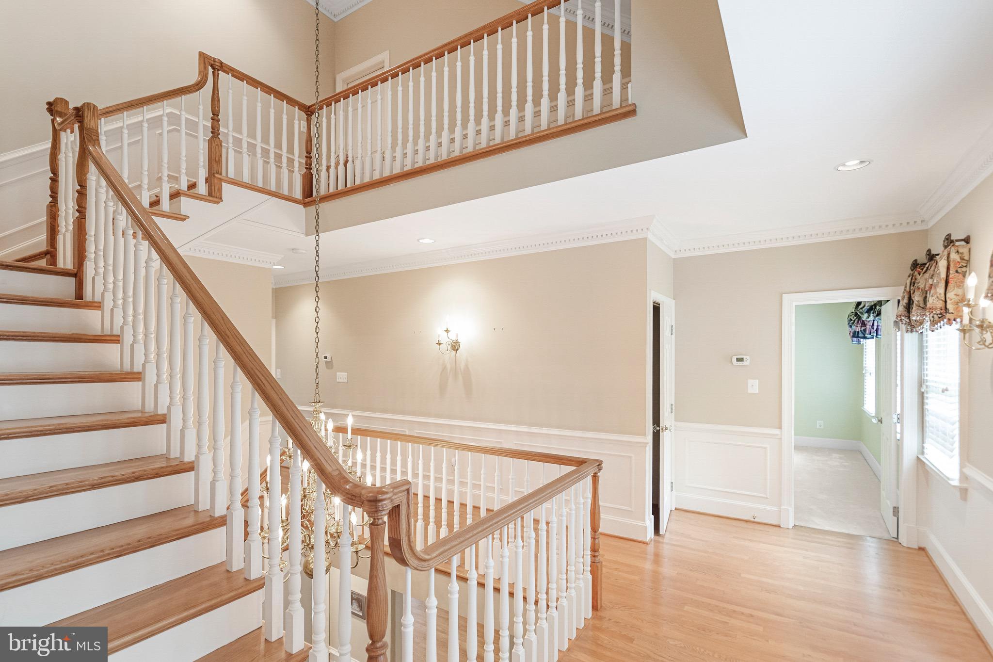 965 St Stephens Church Road Gambrills, MD 21054 - Photo 23 of 43 a view of staircase with lots of frames on wall and wooden floor