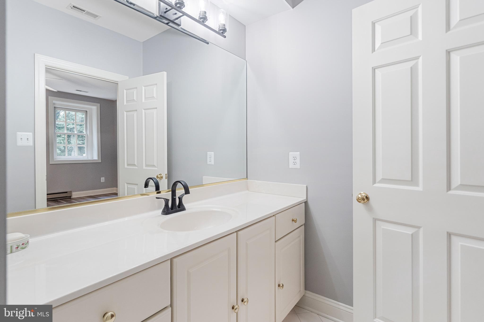 965 St Stephens Church Road Gambrills, MD 21054 - Photo 40 of 43 a bathroom with a sink and a mirror