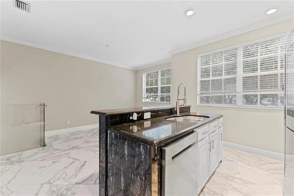 1437 Harbour Walk Road Tampa, FL 33602 - Photo 11 of 32 a kitchen with granite countertop a sink and a stove
