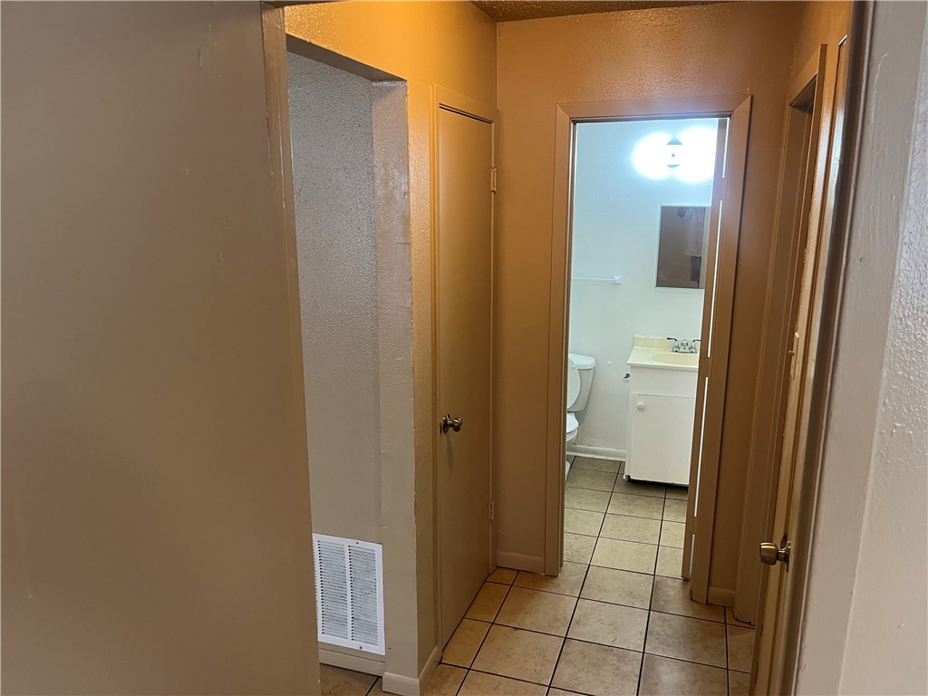942 Weaver Street, Unit 32 Corpus Christi, TX 78418 - Photo 11 of 12 a bathroom with a glass door shower and a sink