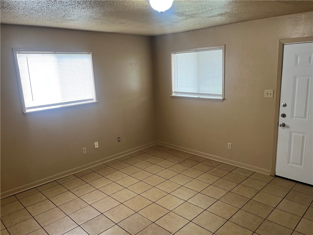 942 Weaver Street, Unit 32 Corpus Christi, TX 78418 - Photo 5 of 12 an empty room with windows