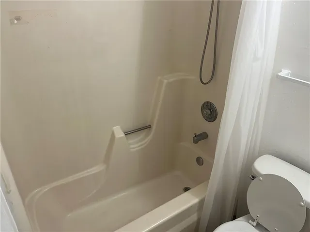 a bathroom with a shower and a toilet