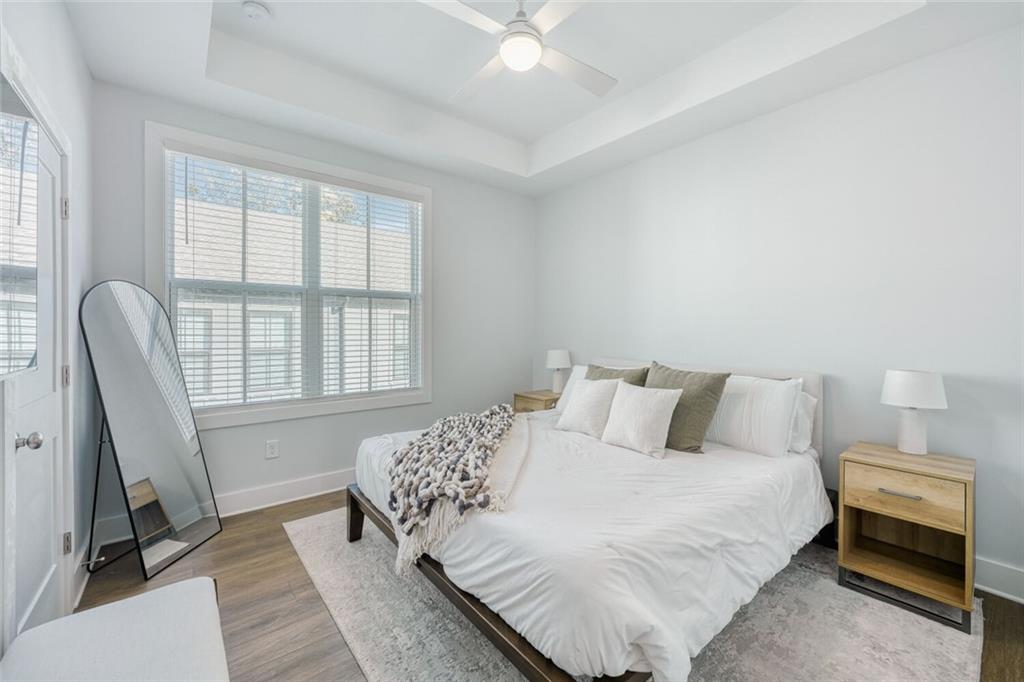 4471 Dandelion Lane Atlanta, GA 30342 - Photo 13 of 30 a bedroom with a bed a couch and a window