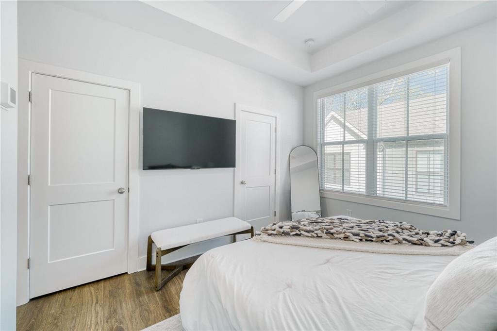 4471 Dandelion Lane Atlanta, GA 30342 - Photo 14 of 30 a bedroom with a bed and a flat screen tv