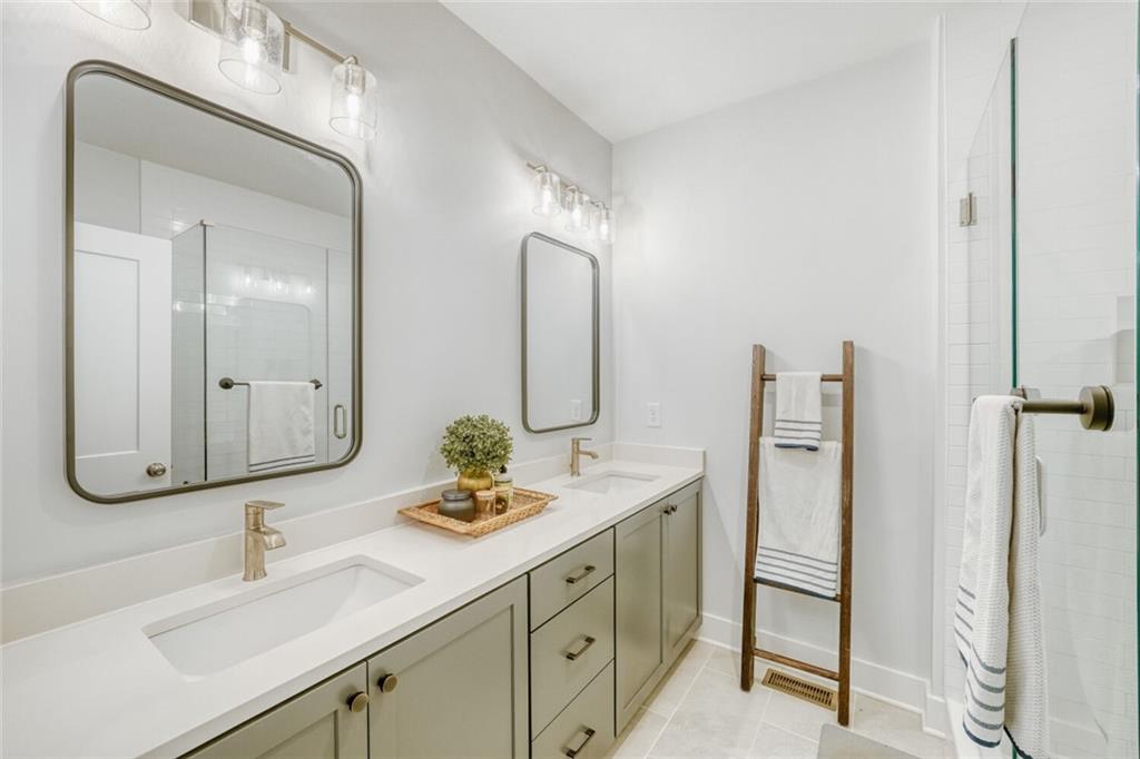 4471 Dandelion Lane Atlanta, GA 30342 - Photo 16 of 30 a bathroom with double vanity sinks and a mirror