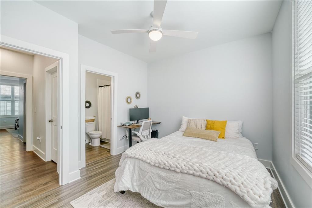 4471 Dandelion Lane Atlanta, GA 30342 - Photo 18 of 30 a bedroom with a bed and wooden floor