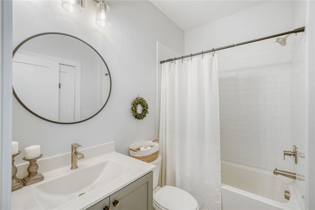 4471 Dandelion Lane Atlanta, GA 30342 - Photo 19 of 30 a bathroom with a sink toilet and a mirror