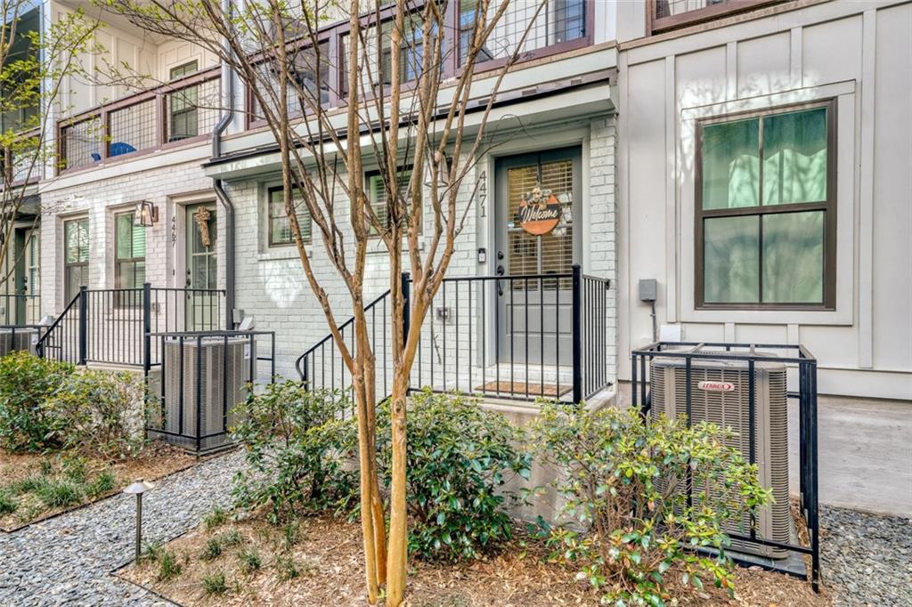 4471 Dandelion Lane Atlanta, GA 30342 - Photo 2 of 30 front view of a brick house with a large windows and a yard