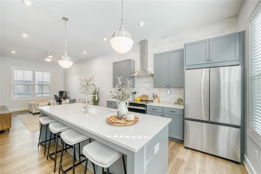 4471 Dandelion Lane Atlanta, GA 30342 - Photo 6 of 30 a kitchen with refrigerator and wooden floor