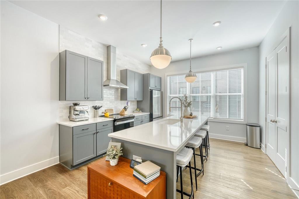 4471 Dandelion Lane Atlanta, GA 30342 - Photo 7 of 30 a large kitchen with a table and chairs