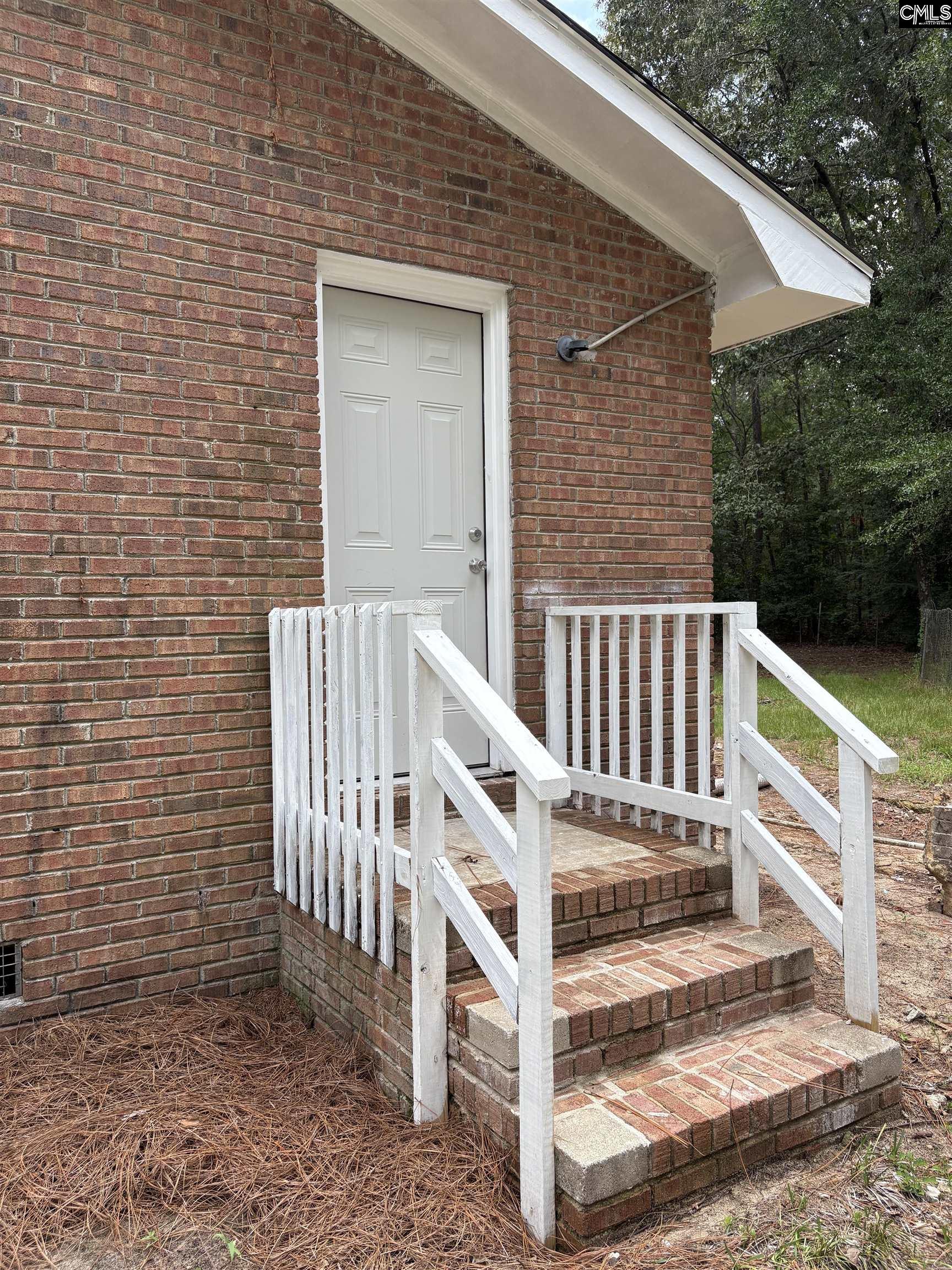 3124 Pine Plain Road Swansea, SC 29160 - Photo 3 of 14 a view of wooden house with a small yard and wooden fence
