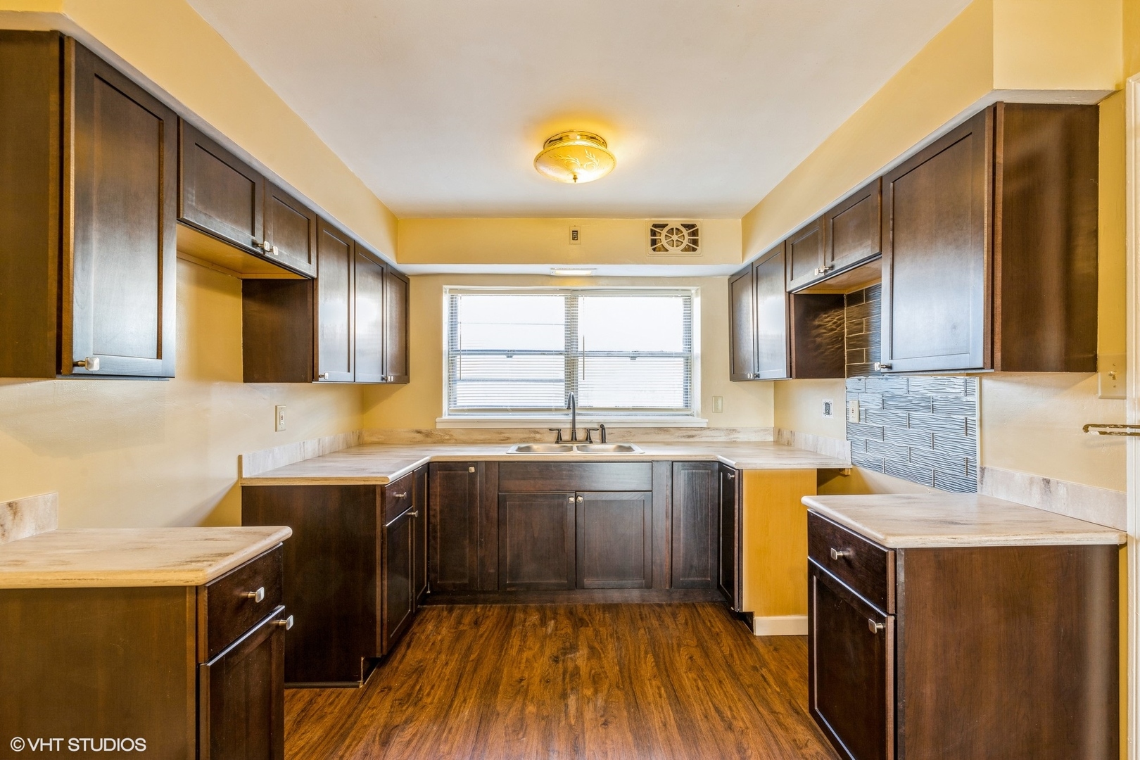 1906 West 80th Street, Unit 1W Chicago, IL 60620 - Photo 11 of 12 a kitchen with a sink a stove and cabinets