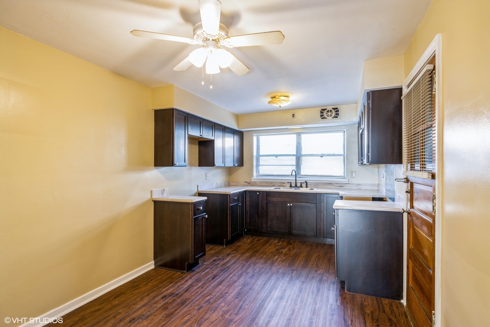 1906 West 80th Street, Unit 1W Chicago, IL 60620 - Photo 10 of 12 a kitchen with stainless steel appliances granite countertop a sink cabinets and wooden floor