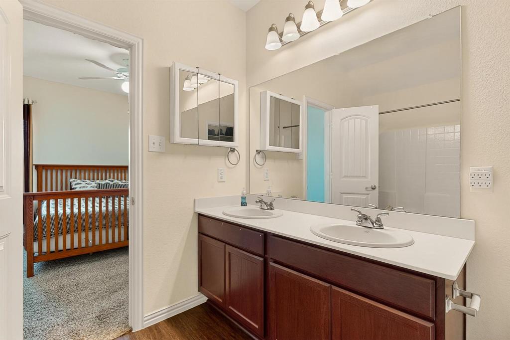9144 St Barts Road Fort Worth, TX 76123 - Photo 20 of 36 Bathroom with double vanity, dark wood finished floors, and ceiling fan