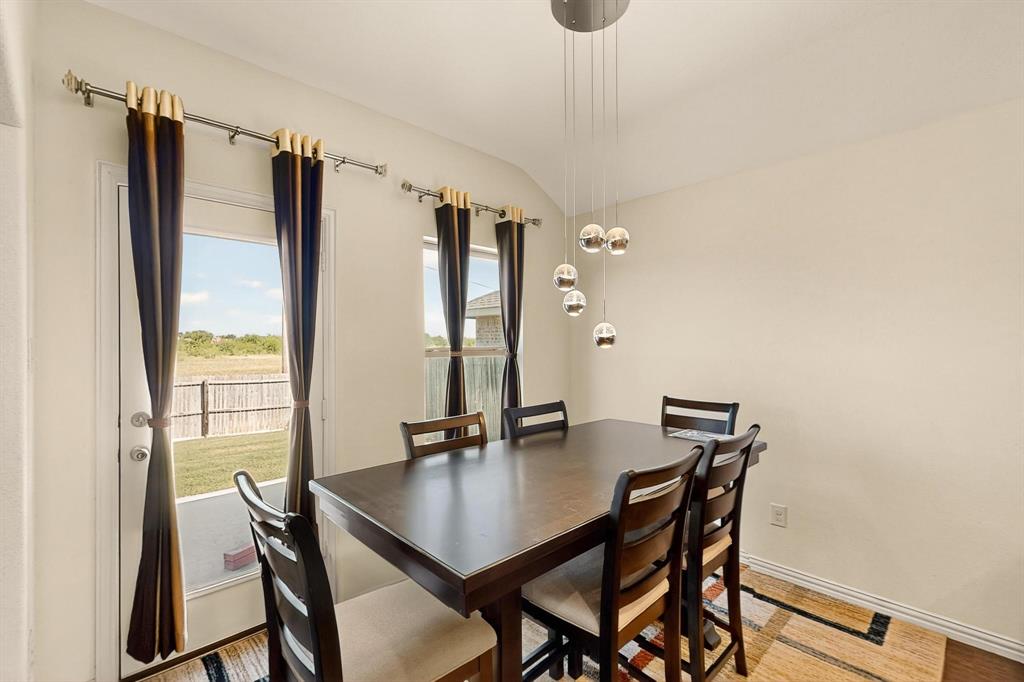 9144 St Barts Road Fort Worth, TX 76123 - Photo 4 of 36 Dining space featuring lofted ceiling and wood finished floors