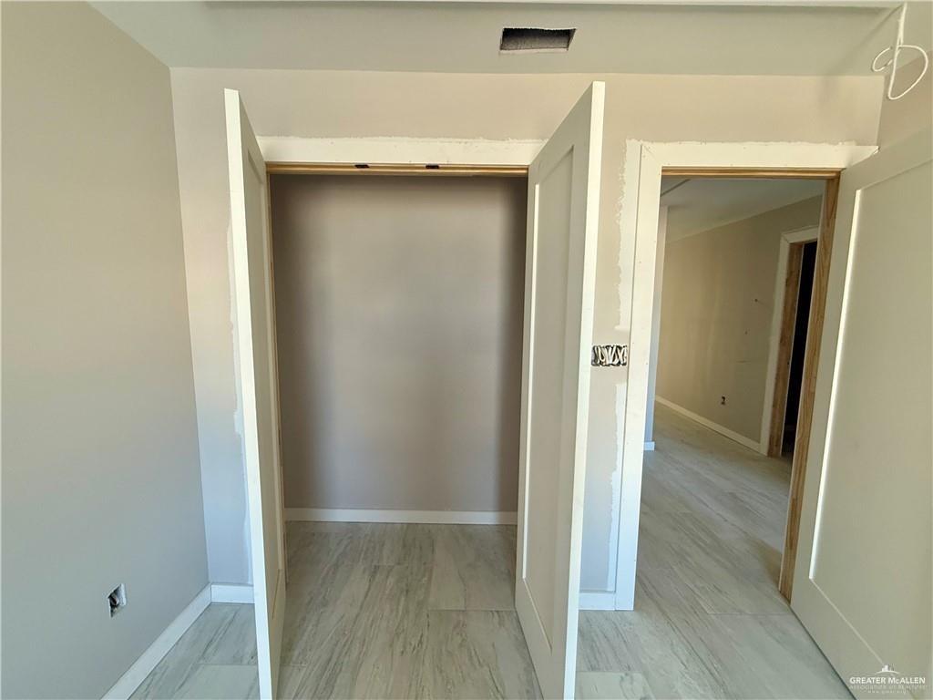 2206 Corales Street Mission, TX 78573 - Photo 14 of 17 a view of a hallway with wooden floor