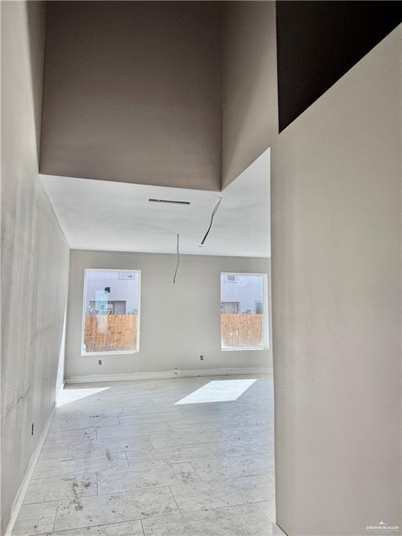 2206 Corales Street Mission, TX 78573 - Photo 2 of 17 an empty room with windows and fan