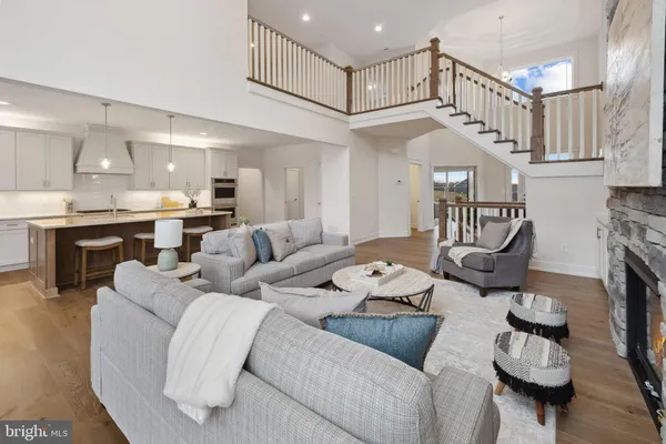 a living room with furniture and a dining table with kitchen view