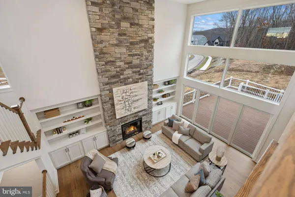 a kitchen with kitchen island granite countertop a stove a sink a oven a dining table and chairs with wooden floor