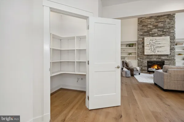 a dining room with furniture and a floor to ceiling window