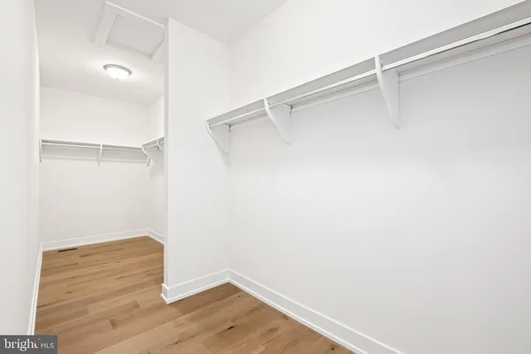 a bathroom with a tub shower sink and mirror