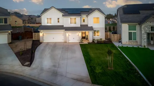 a front view of a house with a yard