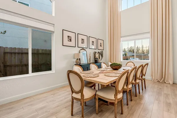 a dining room with furniture and wooden floor