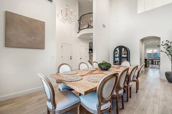 a dining room with furniture and wooden floor