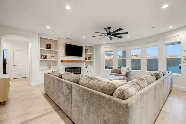a living room with furniture a fireplace and a flat screen tv