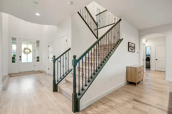 a view of entryway and hall with wooden floor