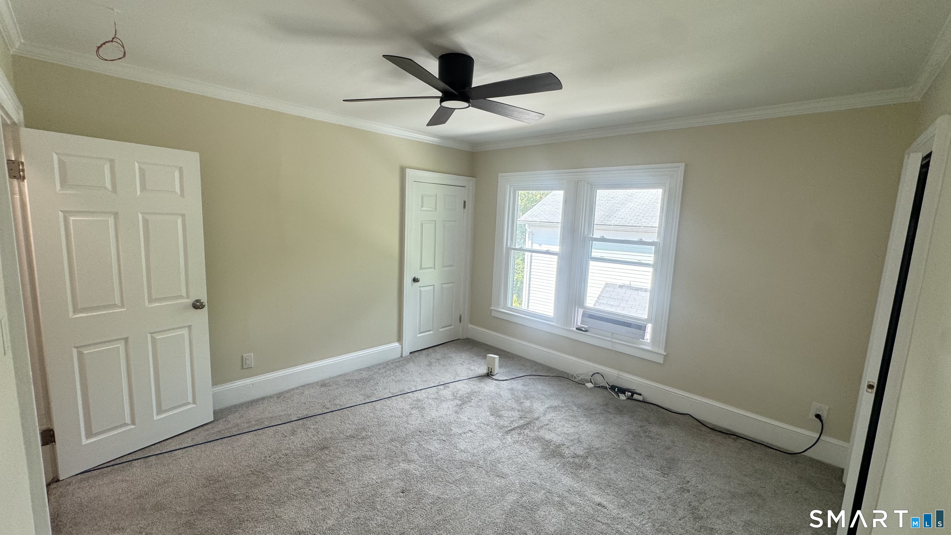 104 Prospect Street Ansonia, CT 06401 - Photo 26 of 40 a view of a livingroom with a ceiling fan & windows