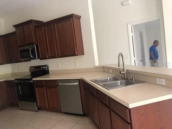 a kitchen with a sink and a microwave