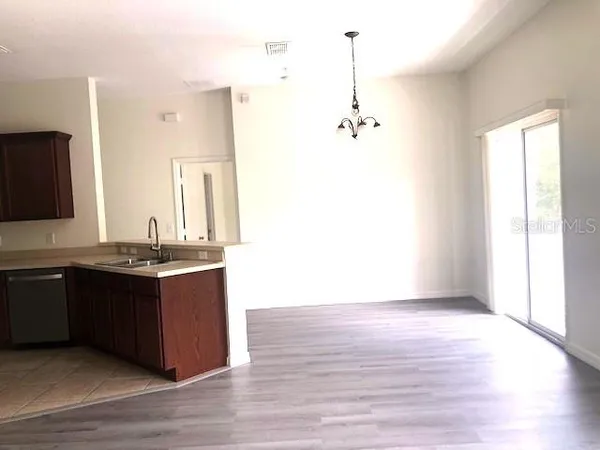 a spacious bathroom with a granite countertop sink and a mirror
