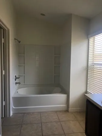 a bath tub sitting next to a window