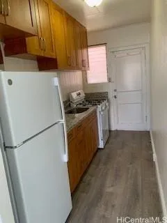 a kitchen with a refrigerator stove and cabinets