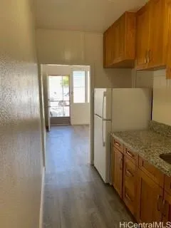 a kitchen with a refrigerator a stove and a sink