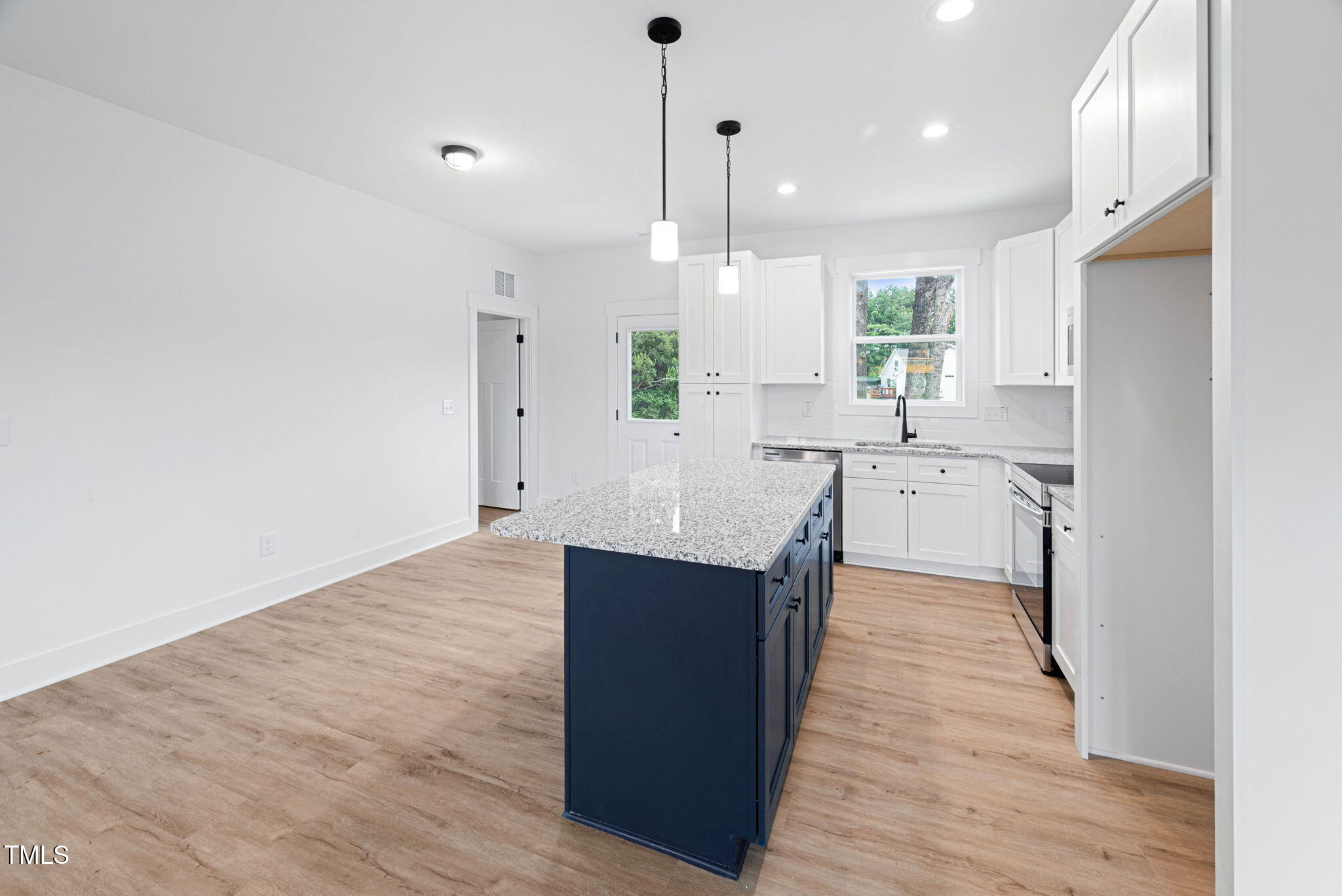 156 Southern Middle School Road Roxboro, NC 27573 - Photo 11 of 32 a large kitchen with stainless steel appliances a large counter top a sink a refrigerator and a window
