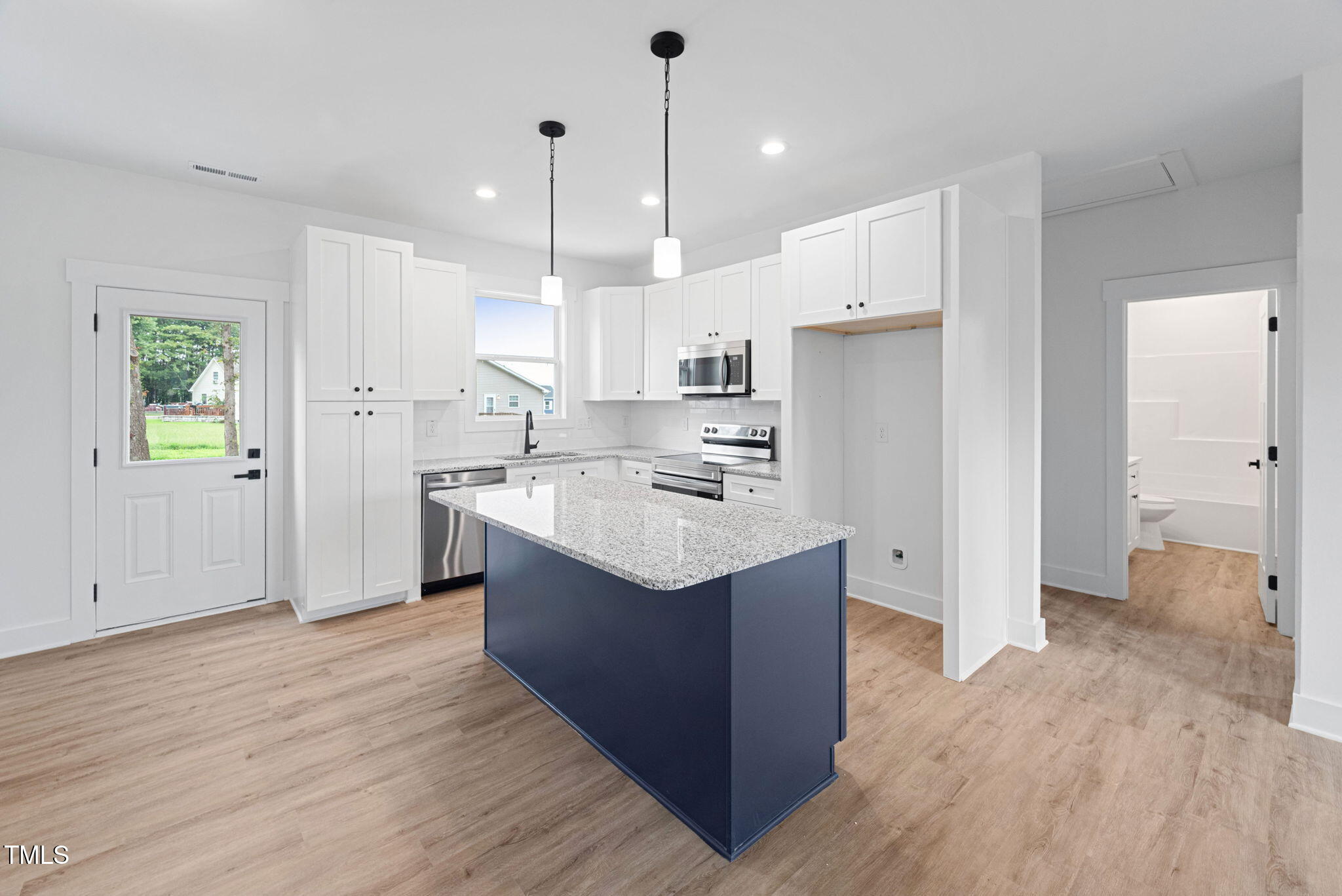 156 Southern Middle School Road Roxboro, NC 27573 - Photo 12 of 32 a kitchen with kitchen island sink stove and refrigerator