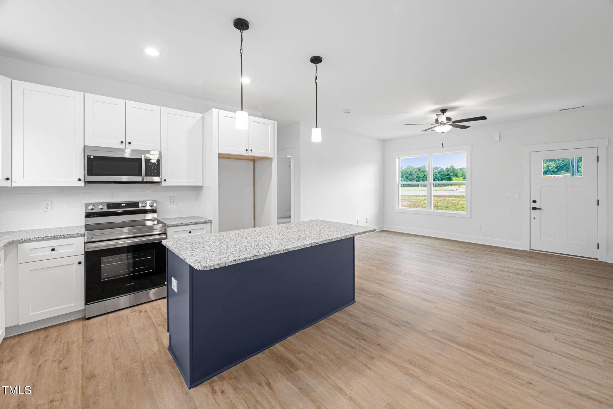 156 Southern Middle School Road Roxboro, NC 27573 - Photo 13 of 32 a kitchen with stainless steel appliances a stove a refrigerator and a sink