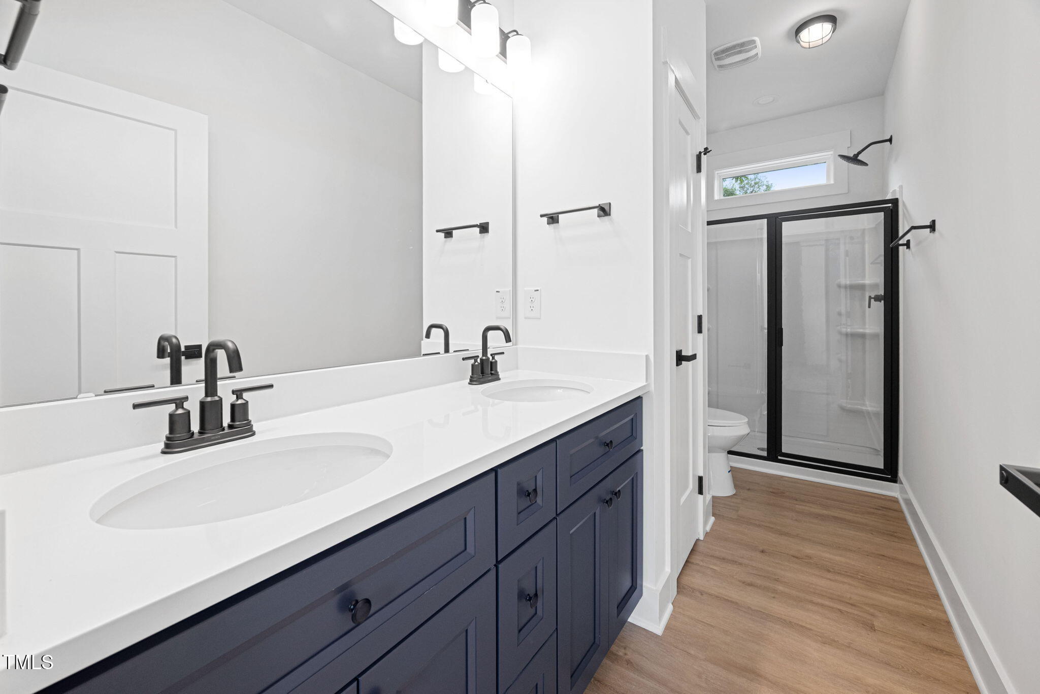 156 Southern Middle School Road Roxboro, NC 27573 - Photo 17 of 32 a bathroom with a double vanity sink mirror and