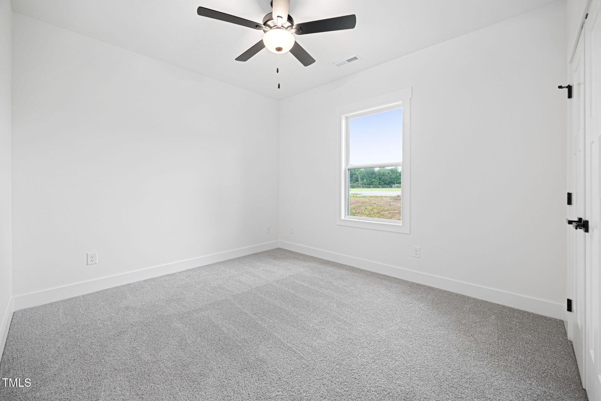 156 Southern Middle School Road Roxboro, NC 27573 - Photo 24 of 32 an empty room with a window and a fan