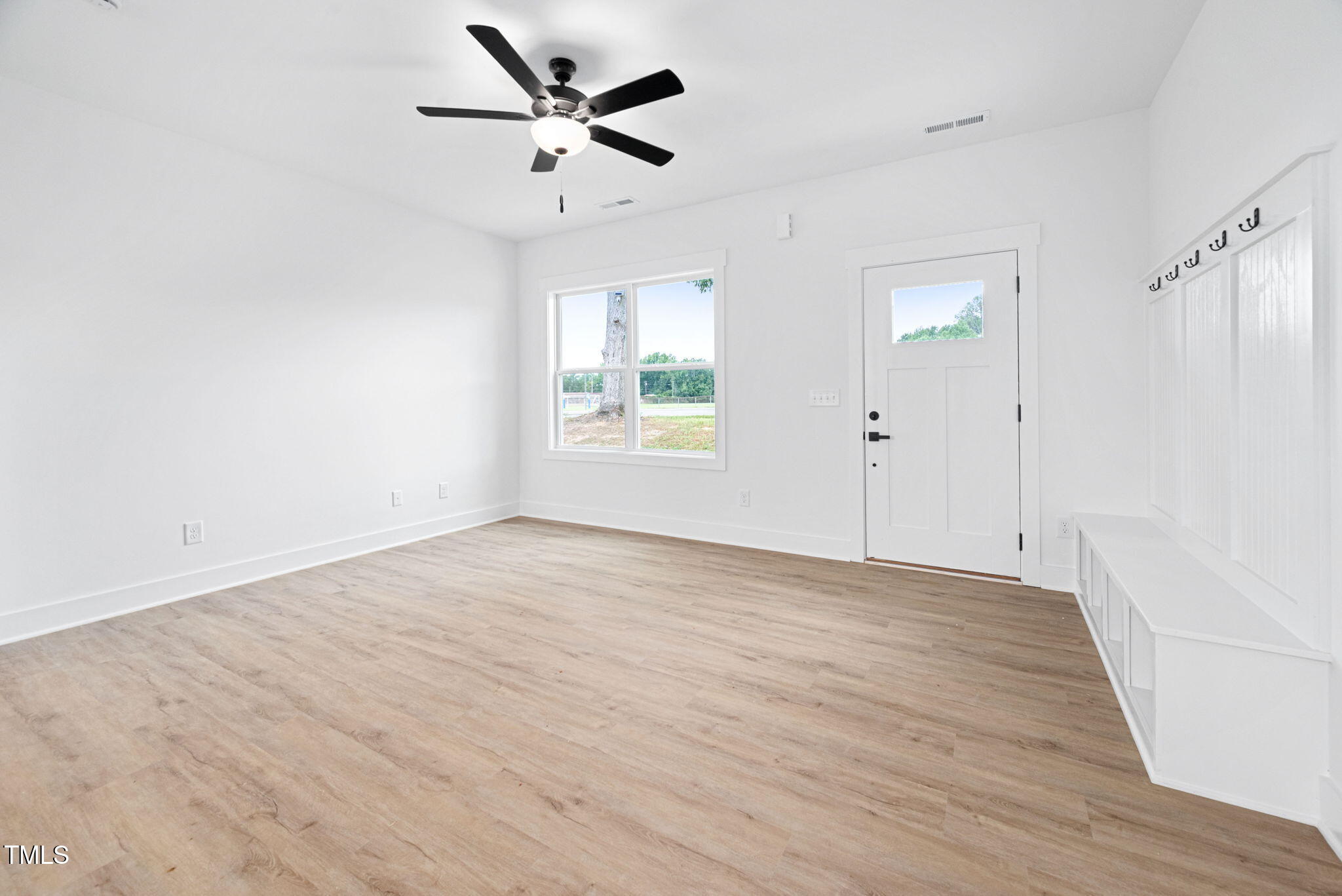 156 Southern Middle School Road Roxboro, NC 27573 - Photo 8 of 32 an empty room with wooden floor fan and windows
