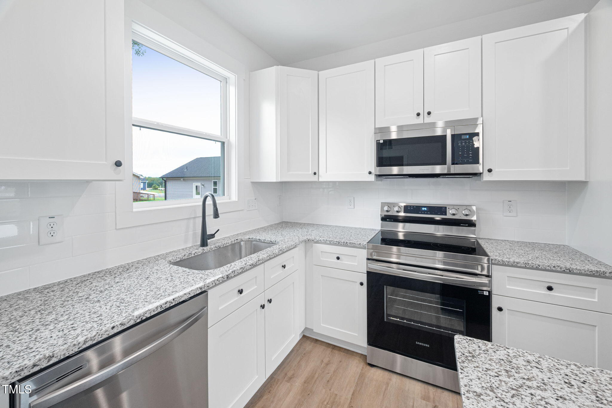 156 Southern Middle School Road Roxboro, NC 27573 - Photo 9 of 32 a kitchen with granite countertop a sink a stove and microwave