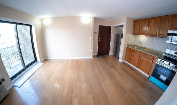 a view of a kitchen with wooden floor and a sink